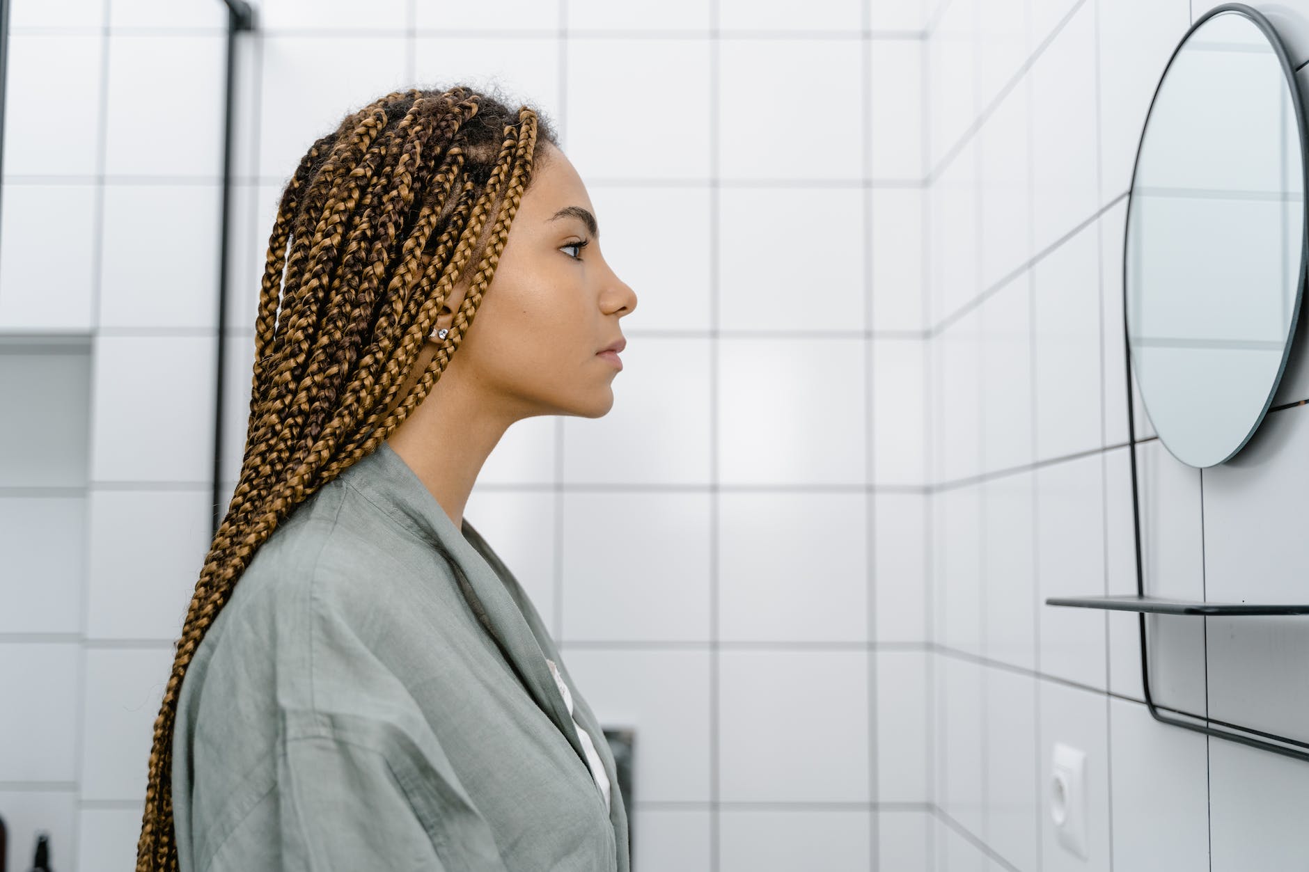 a woman looking at the mirror